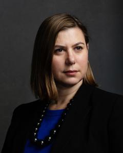 Elissa Slotkin wearing a blue sweater, black necklace, black jacket