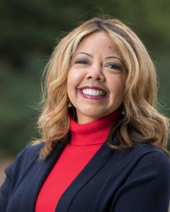 Lucy McBath in a red turtleneck smiling