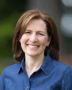 Rep. Schrier next to the American flag